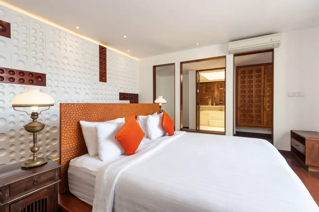 Bedroom with king bed and orange accents at villa in Batu Belig, Bali