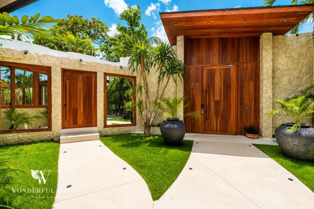 Garden entrance path to timber door at family villa in Umalas, Bali