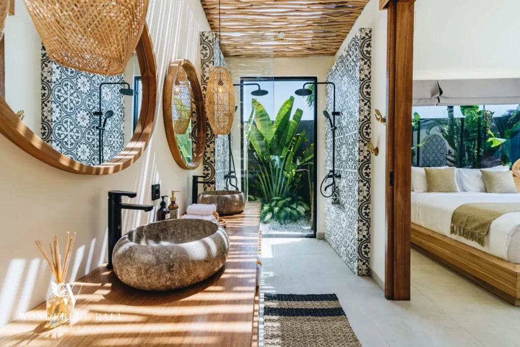 Bathroom with vessel basin, round mirrors and plants at villa in Seseh, Bali