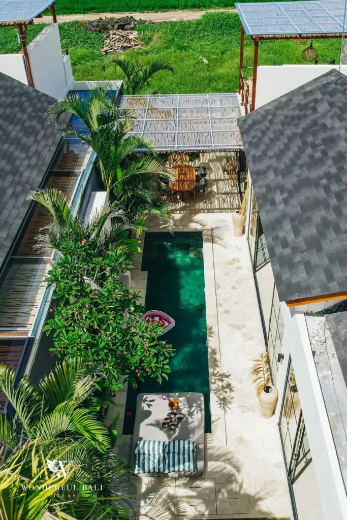 Plunge pool with patterned tile and tropical plants at villa in Seseh, Bali