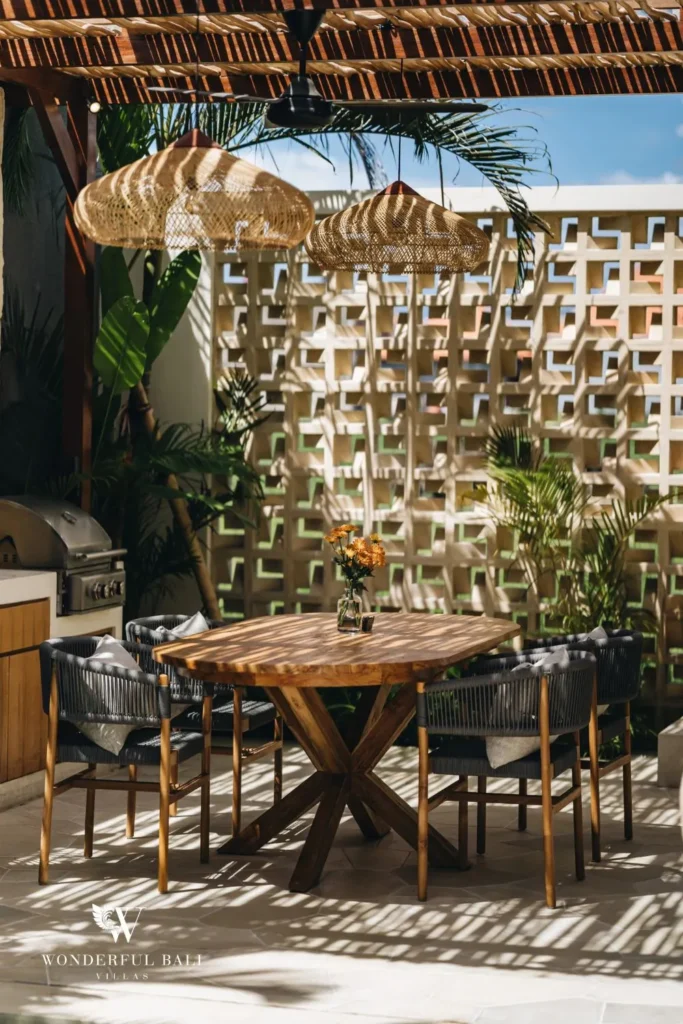 Outdoor dining with rattan chairs under a bamboo roof at villa in Seseh, Bali
