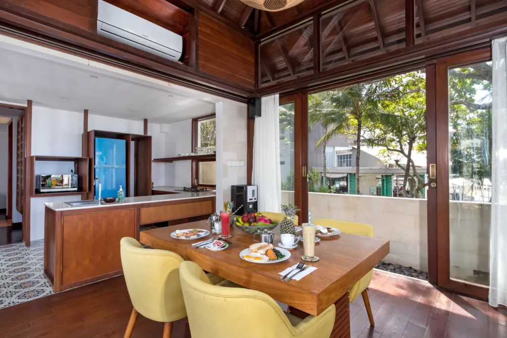 Dining area with bench seating and timber table at villa in Batu Belig, Bali