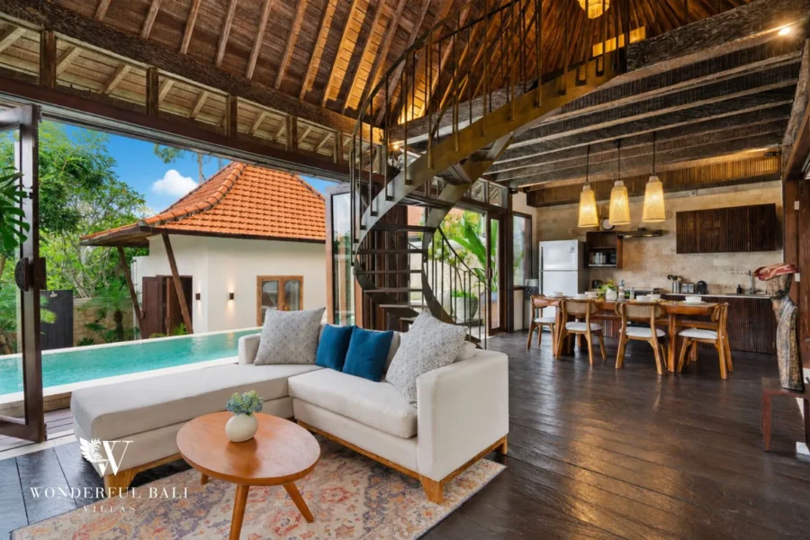 3BR tropical villa in Pererenan — open-plan living and dining under a thatched roof beside the private pool, Canggu