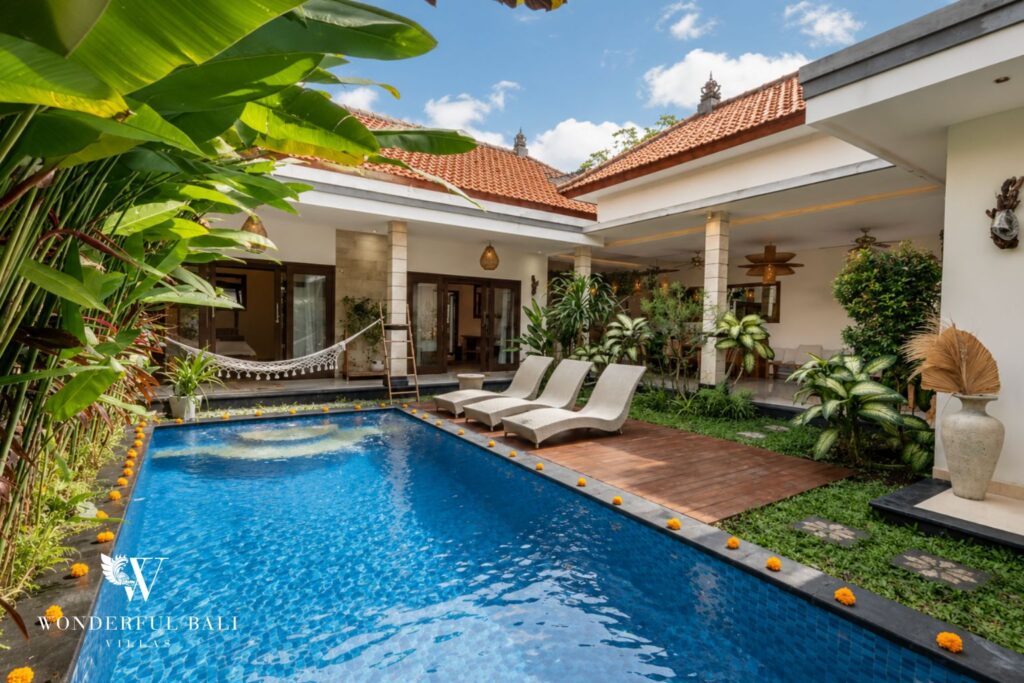 Private pool with timber sun deck and open living pavilion at a villa in Batu Bolong, Canggu