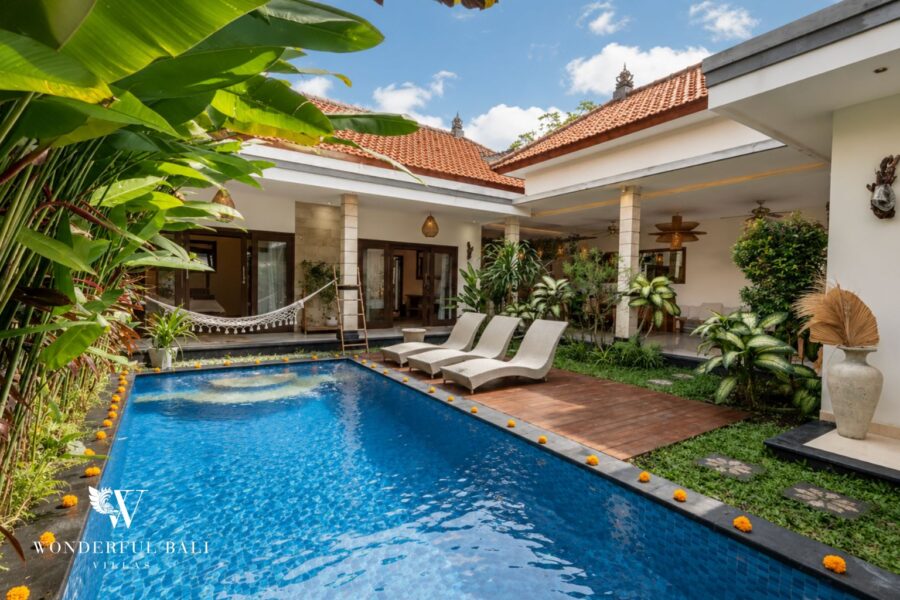 Private pool with timber sun deck and open living pavilion at a villa in Batu Bolong, Canggu