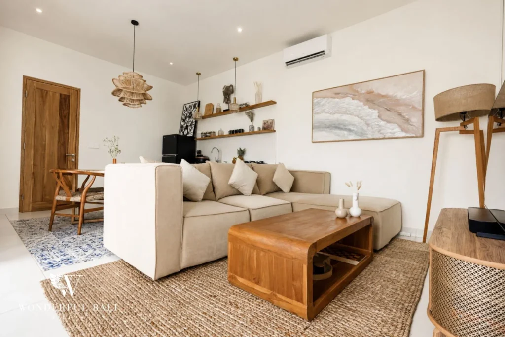 Living and dining area with teak furniture and rattan pendant in a 2-bedroom villa in Cemagi Bali