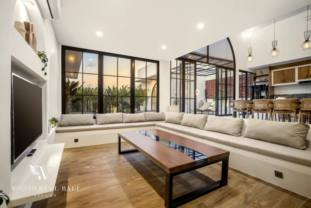 Open-plan living room with sectional sofa and smart TV at a 3-bedroom villa in Pererenan, Bali