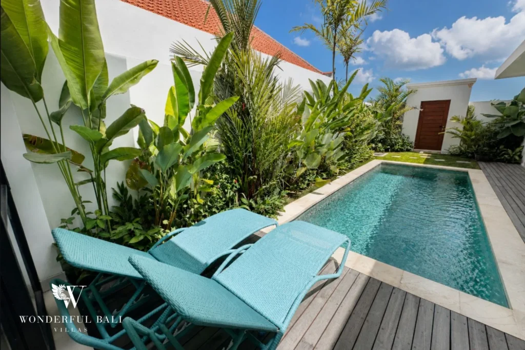 Sun loungers on the timber pool deck of a 2-bedroom villa in Seseh Bali