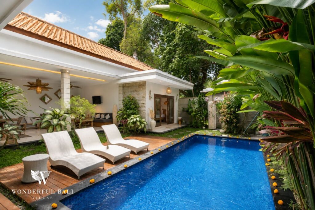 Private pool with timber sun deck and loungers at a villa in Batu Bolong, Canggu