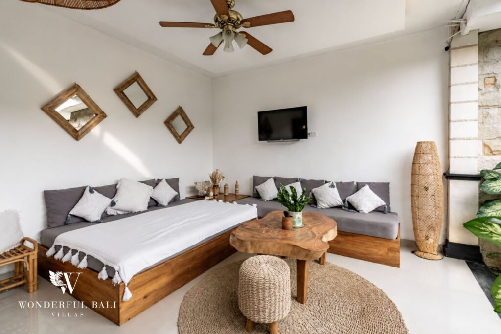 Boho living room with sofa and flat-screen TV at a villa in Batu Bolong, Canggu