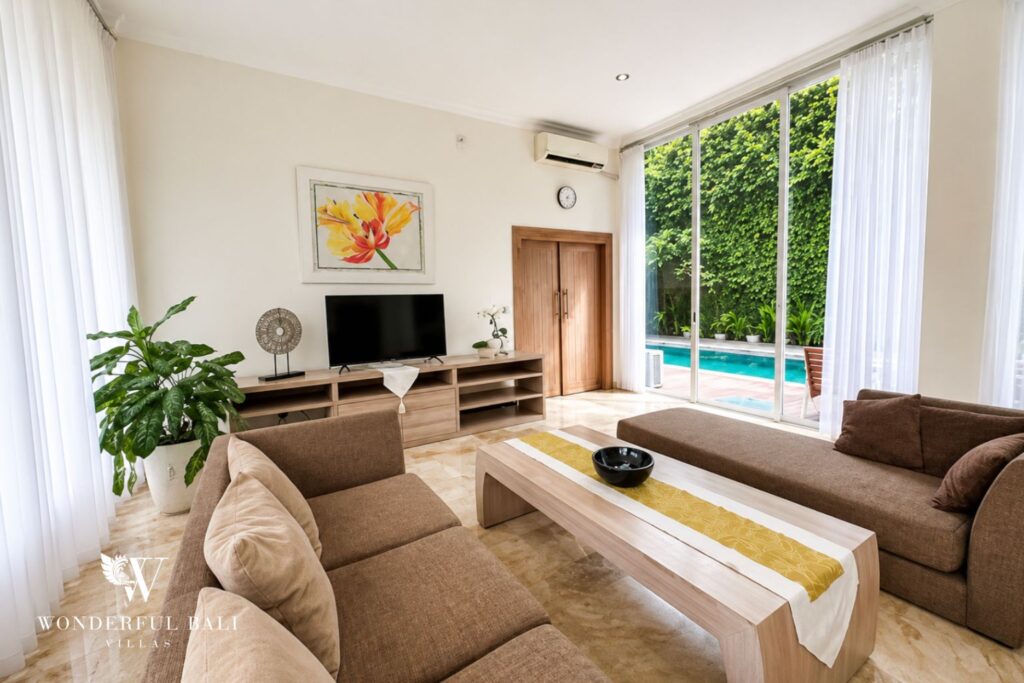 Living room with smart TV opening to the garden at a villa in Seminyak