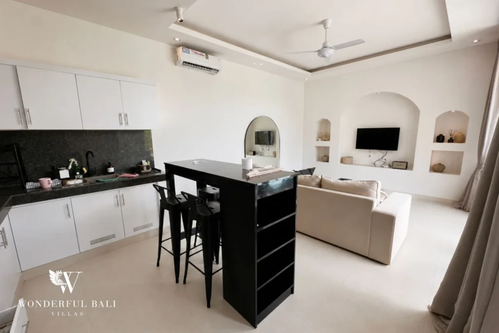 Open-plan kitchen with black granite counter and breakfast bar in a 2-bedroom villa in Seseh Bali