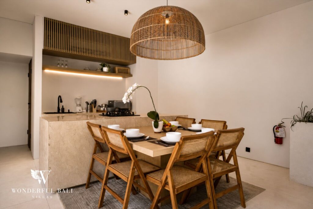 Kitchen and dining area with rattan pendant at a villa in Petitenget, Seminyak