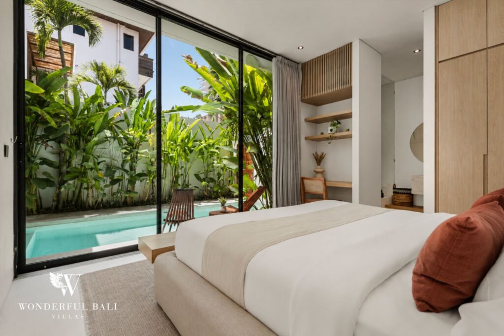 En-suite king bedroom opening to the pool at a villa in Petitenget, Seminyak
