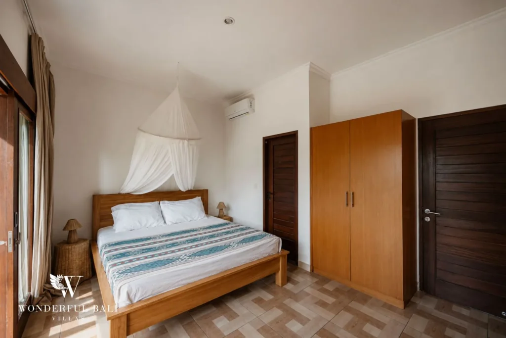 2BR tropical family villa in Berawa — bedroom with canopy bed