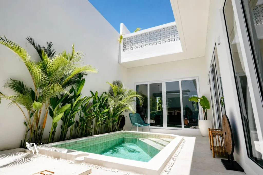 Courtyard plunge pool below a white breeze-block screen at a 2-bedroom villa in Cemagi Bali