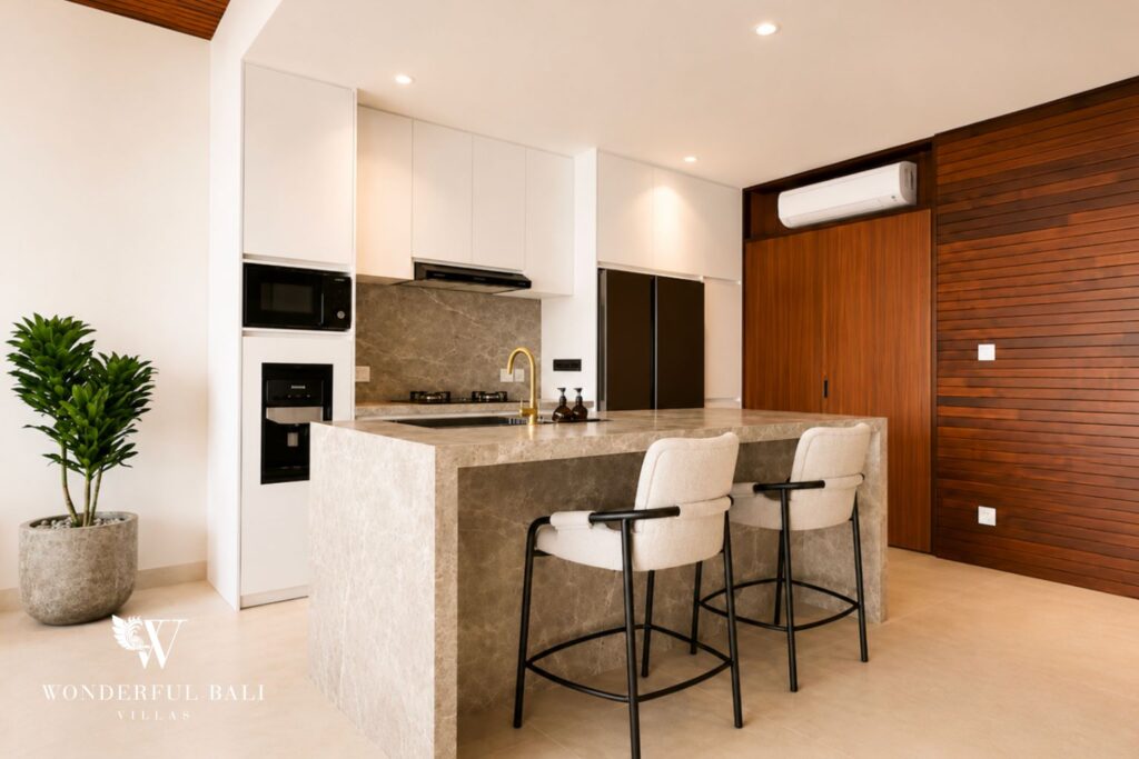 Full kitchen with breakfast island and bar stools at a villa in Berawa, Canggu