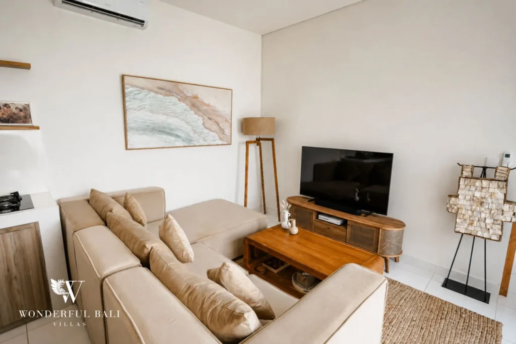 Living room with modular sofa and teak media unit in a 2-bedroom villa in Cemagi Bali