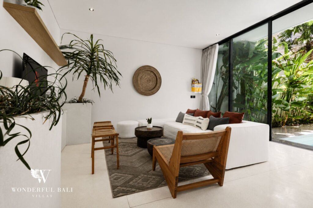 Living room with lounge seating and plants at a villa in Petitenget, Seminyak
