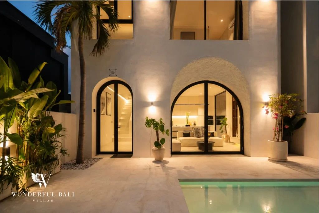 3BR ocean-view villa in Seseh — living room with arched doors at dusk