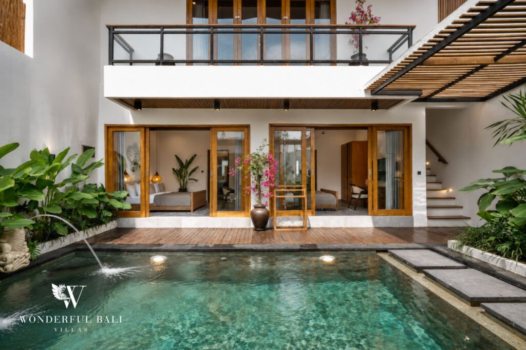 Private pool in a double-height timber atrium at a villa in Canggu