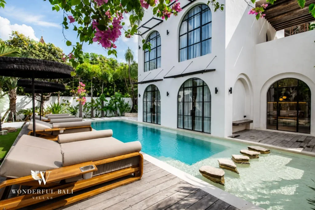 Swimming pool with stone stepping pads and sun shelf at a 4-bedroom villa in Canggu Bali