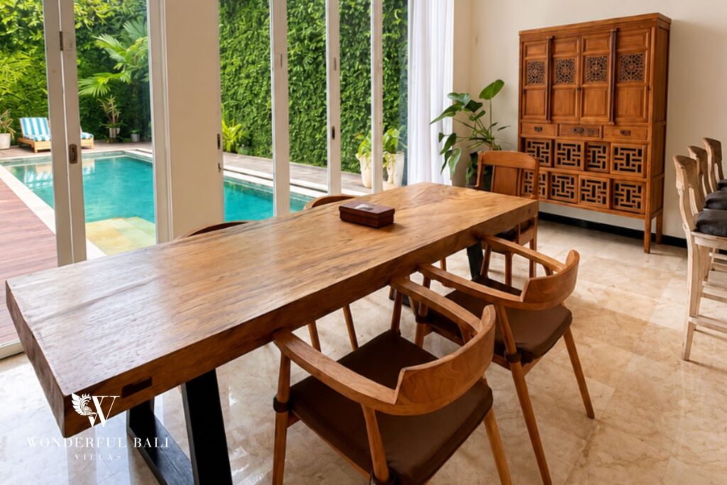 Dining area with large timber table at a villa in Seminyak