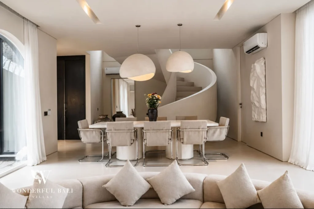 Dining area with sculptural white spiral staircase at a modern villa in Umalas, Bali