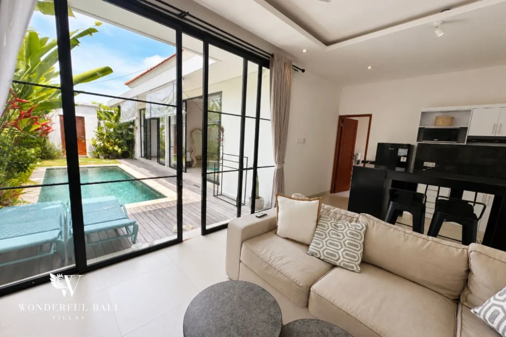 Living room looking out to the private pool and garden of a 2-bedroom villa in Seseh Bali