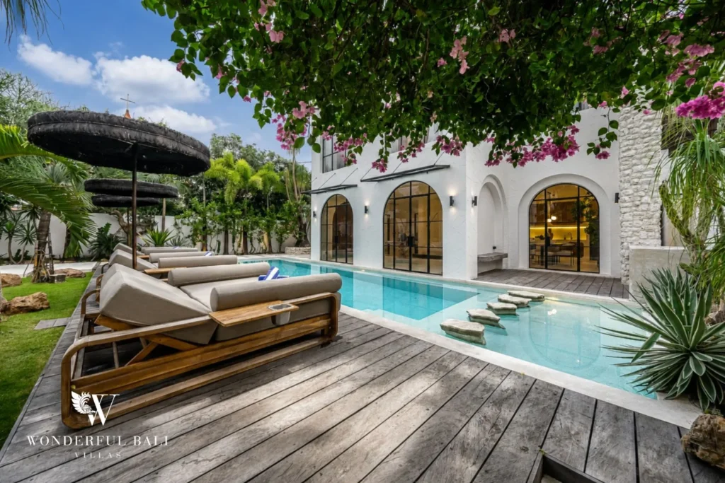 Pool and villa framed by bougainvillea at a 4-bedroom villa in Canggu Bali