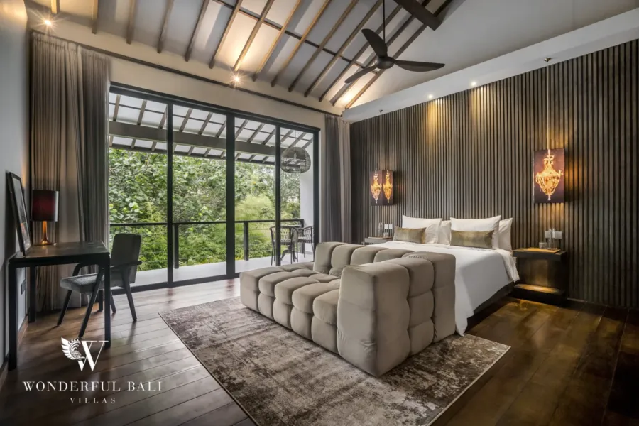 2BR villa for rent in Pererenan — bedroom, an upstairs bedroom with a lofty pitched ceiling, king bed, desk and glass doors to a private balcony with garden views at a 2-bedroom villa