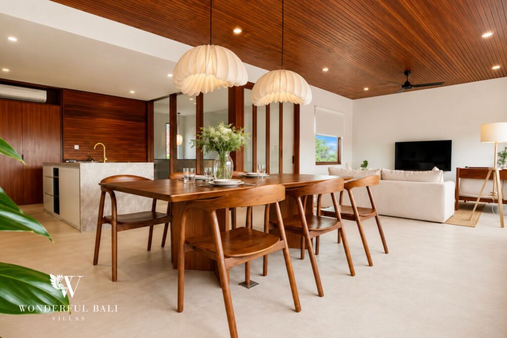 Dining area with timber table and pendant lights at a villa in Berawa, Canggu