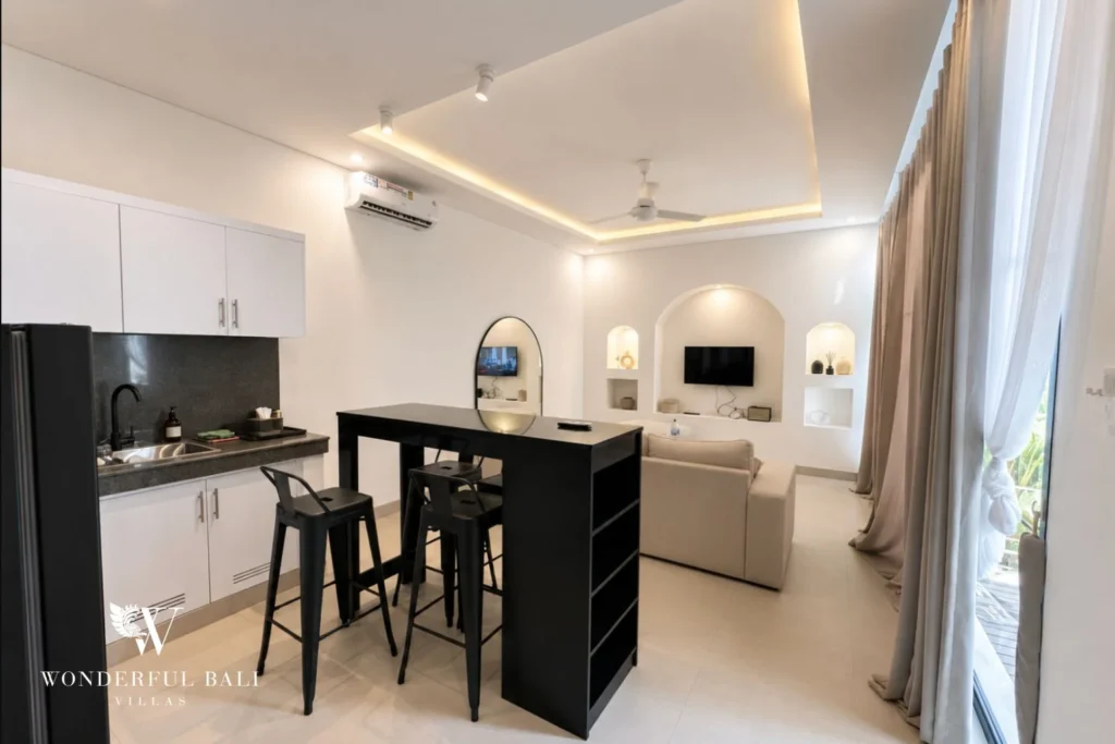 Kitchen island and bar stools under cove lighting in a 2-bedroom villa in Seseh Bali