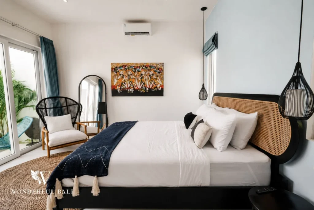Bedroom with glass doors opening to the pool courtyard in a 2-bedroom villa in Cemagi Bali