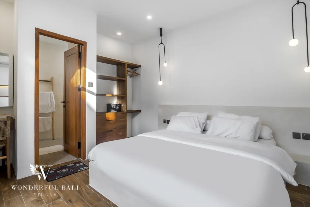 Bedroom with ensuite bathroom and wardrobe at a 3-bedroom villa in Pererenan, Bali