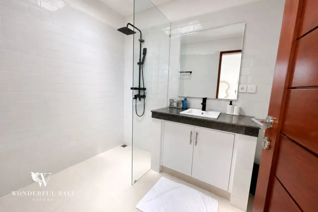 Bathroom with walk-in rain shower and granite vanity in a 2-bedroom villa in Seseh Bali