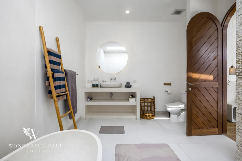 Bedroom with floor-to-ceiling sliding doors opening directly onto the private pool and courtyard at a 3-bedroom villa in Bingin, Uluwatu, Bali