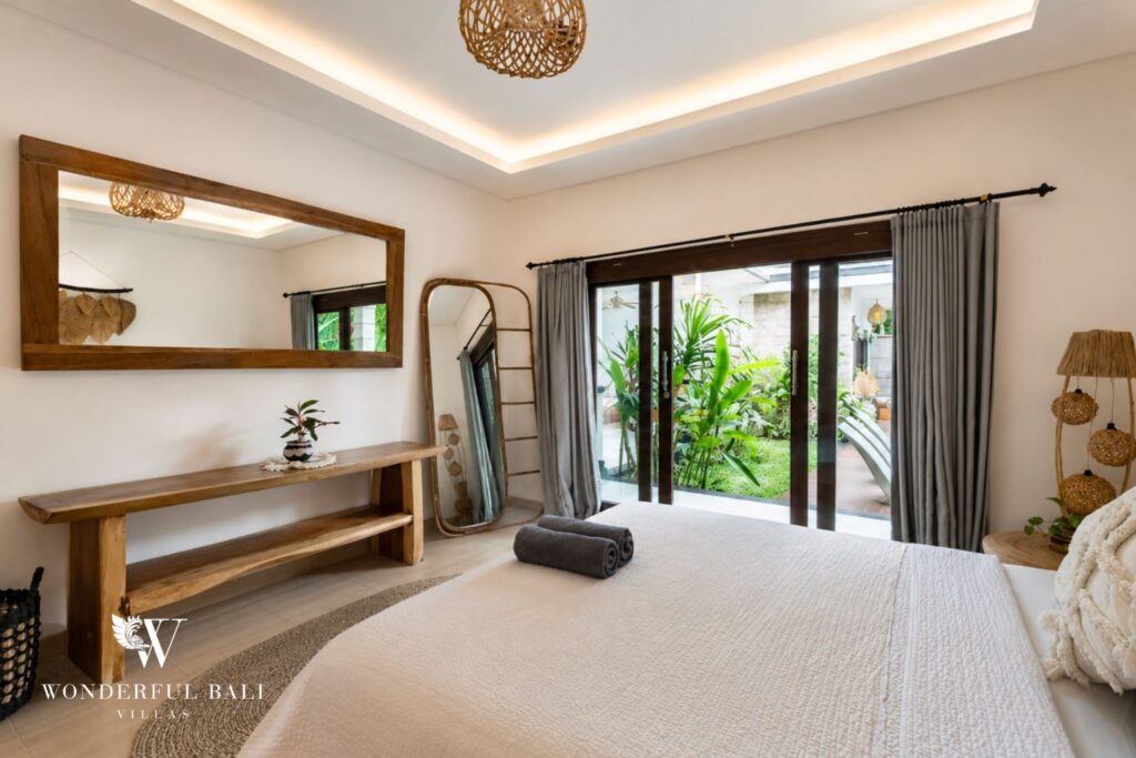 Boho en-suite bedroom with dresser and pool access at a villa in Batu Bolong, Canggu