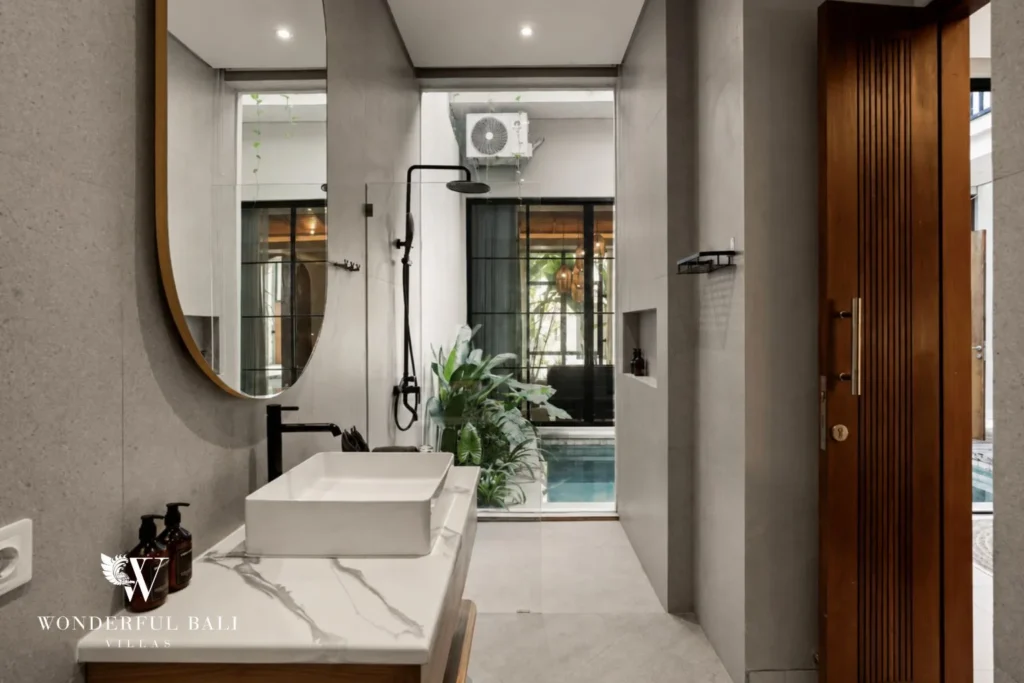 2BR modern villa in Canggu — en suite bathroom with round mirror