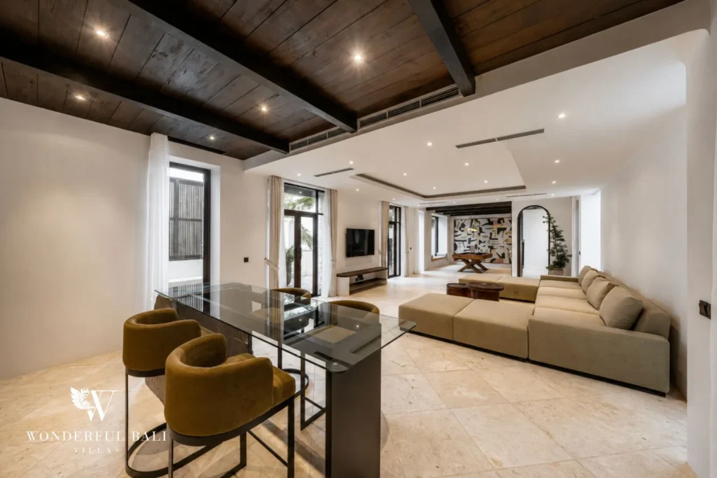 Entertainment lounge with oversized sofa and glass desk in a 4-bedroom villa in Canggu Bali