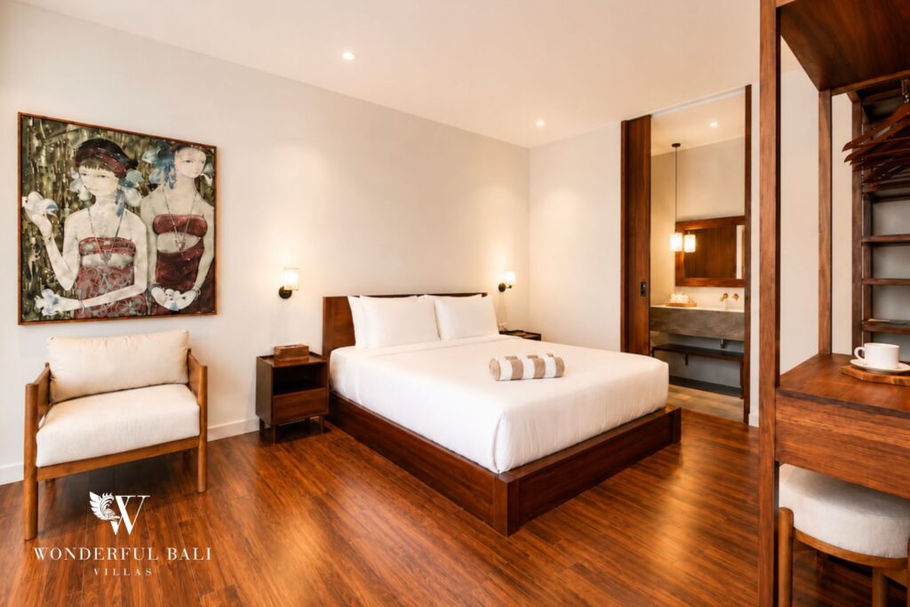 King bedroom with open wardrobe and artwork at a villa in Berawa, Canggu
