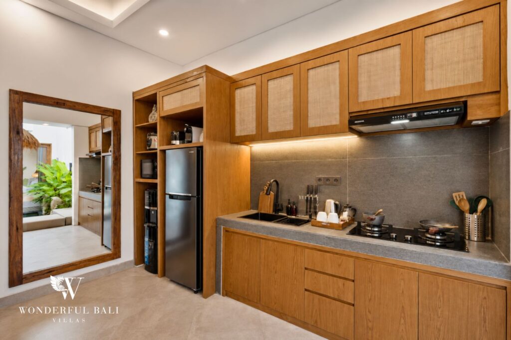 Fully equipped kitchen with timber cabinetry at a villa in Canggu