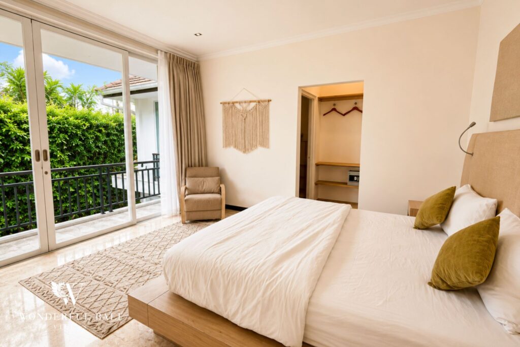 Upstairs bedroom with king bed and balcony at a villa in Seminyak