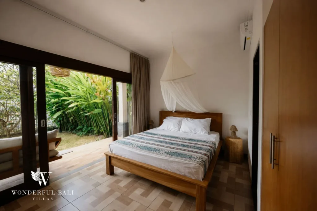 2BR tropical family villa in Berawa — bedroom opening to garden