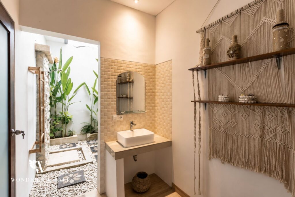 En-suite bathroom with vanity and mirror at a villa in Batu Bolong, Canggu