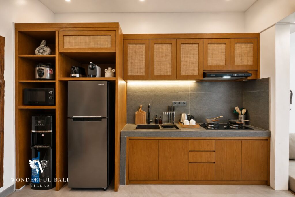 Kitchen with fridge/freezer and timber cabinetry at a villa in Canggu