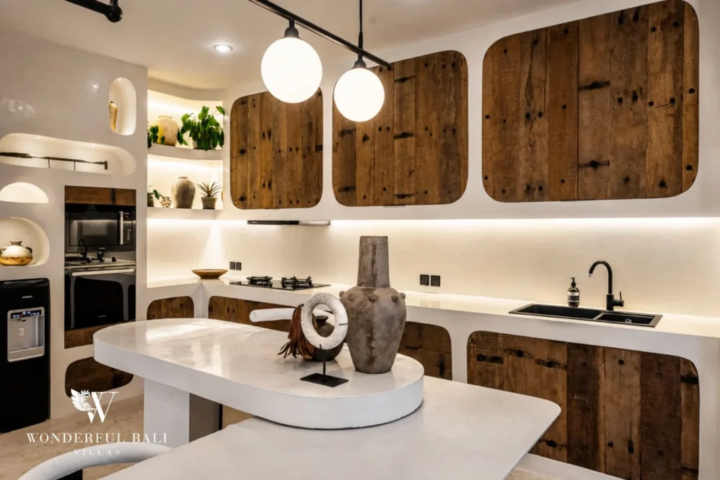 Kitchen with reclaimed timber cabinet fronts and curved plaster shelving in a 4-bedroom villa in Canggu Bali