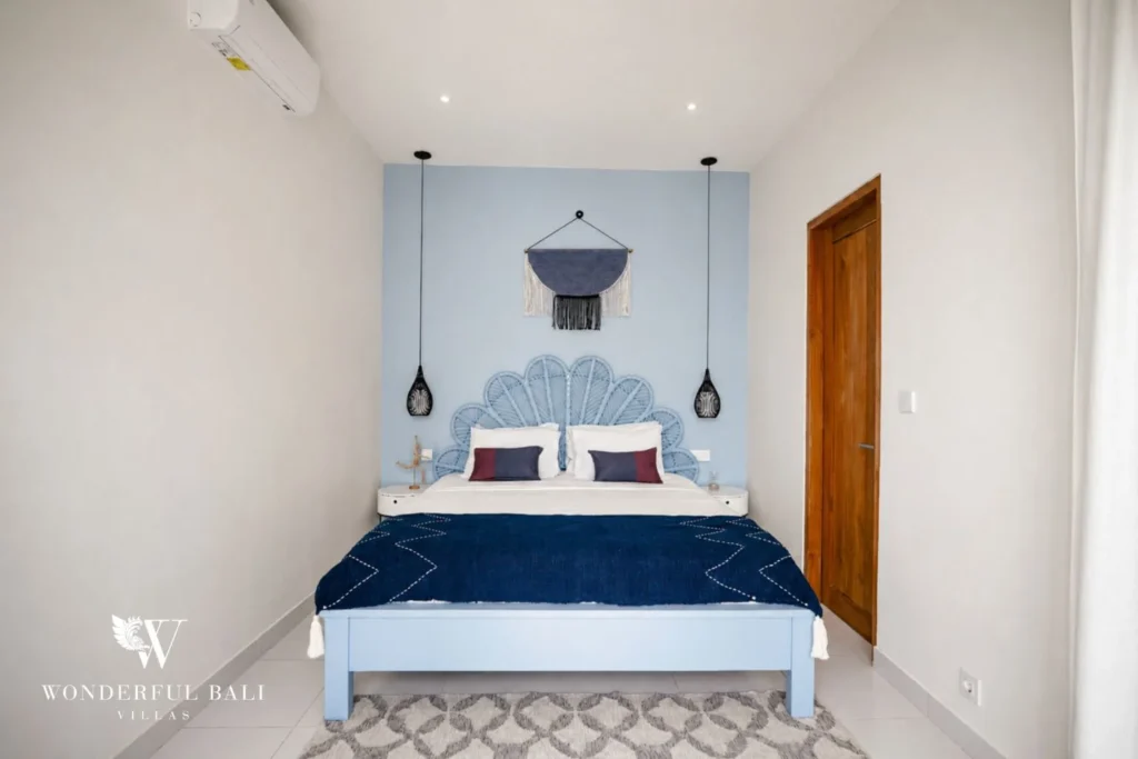 Second bedroom with fan-shaped rattan headboard in a 2-bedroom villa in Cemagi Bali