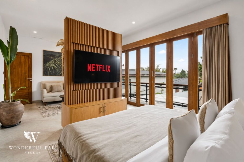 Master en-suite bedroom with king bed and smart TV at a villa in Canggu