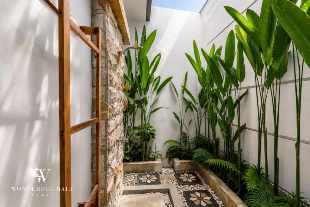 Outdoor detail with woven wall decor and stone at a villa in Batu Bolong, Canggu